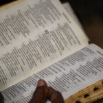 pexels-pamanjoe-28907997 Visual of someone holding a Bible open